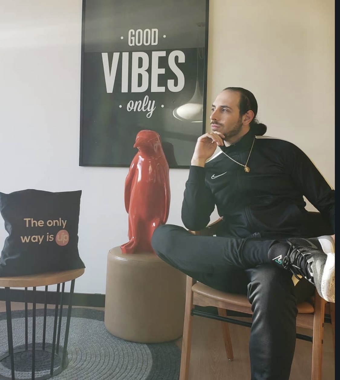Tony, manager of SFH 509, seated in a chair in a black tracksuit